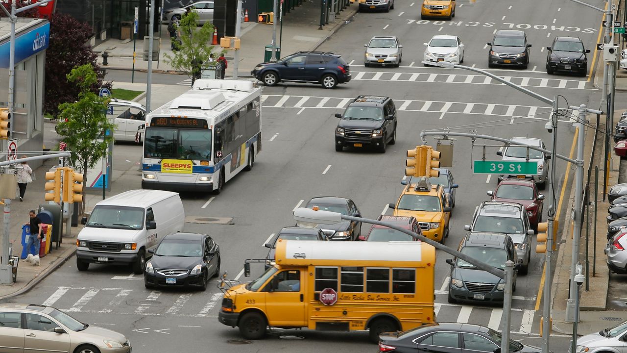 An MTA bus navigates traffic on Tuesday, May 24, 2016 in the Queens borough of New York.