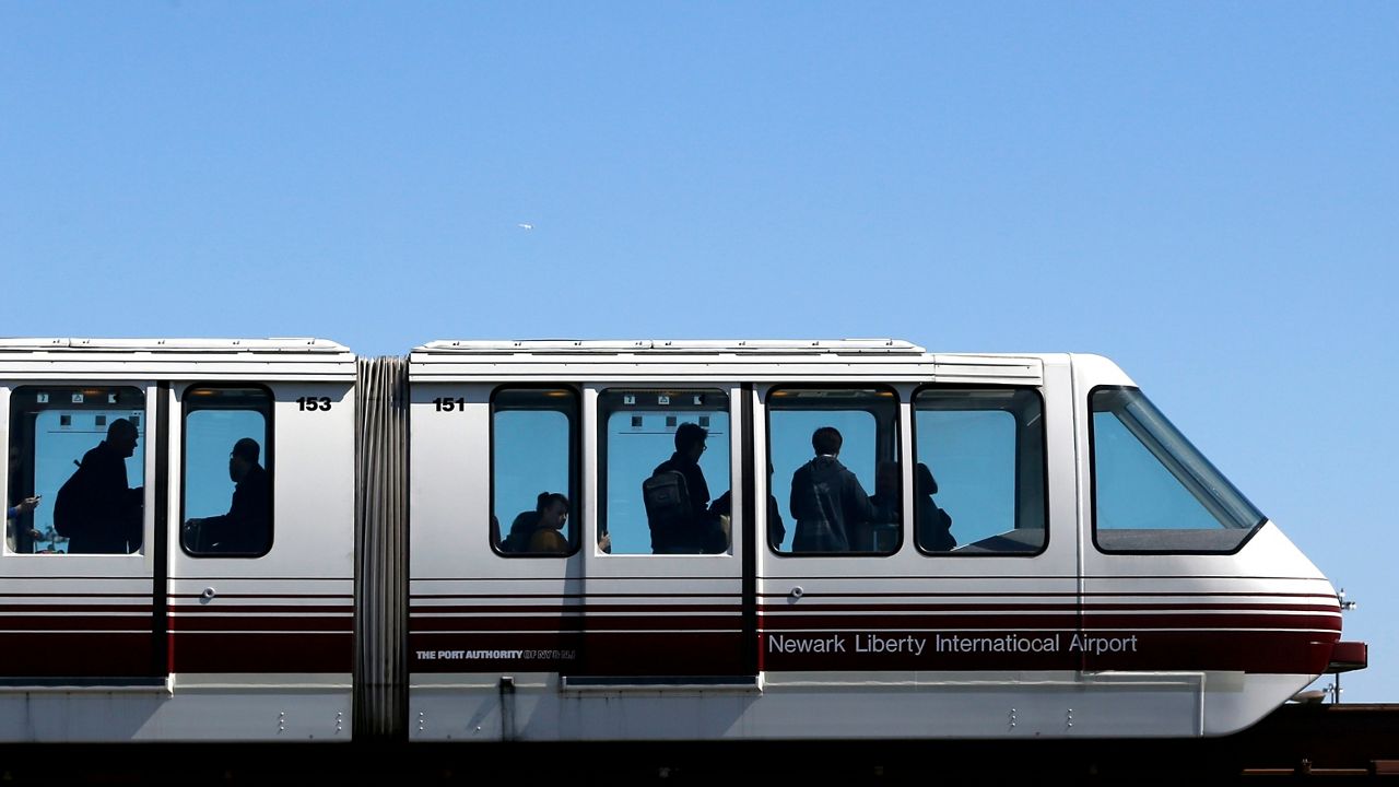 Travelers ride on the AirTrain at Newark Liberty International Airport in Newark on April 24, 2014.