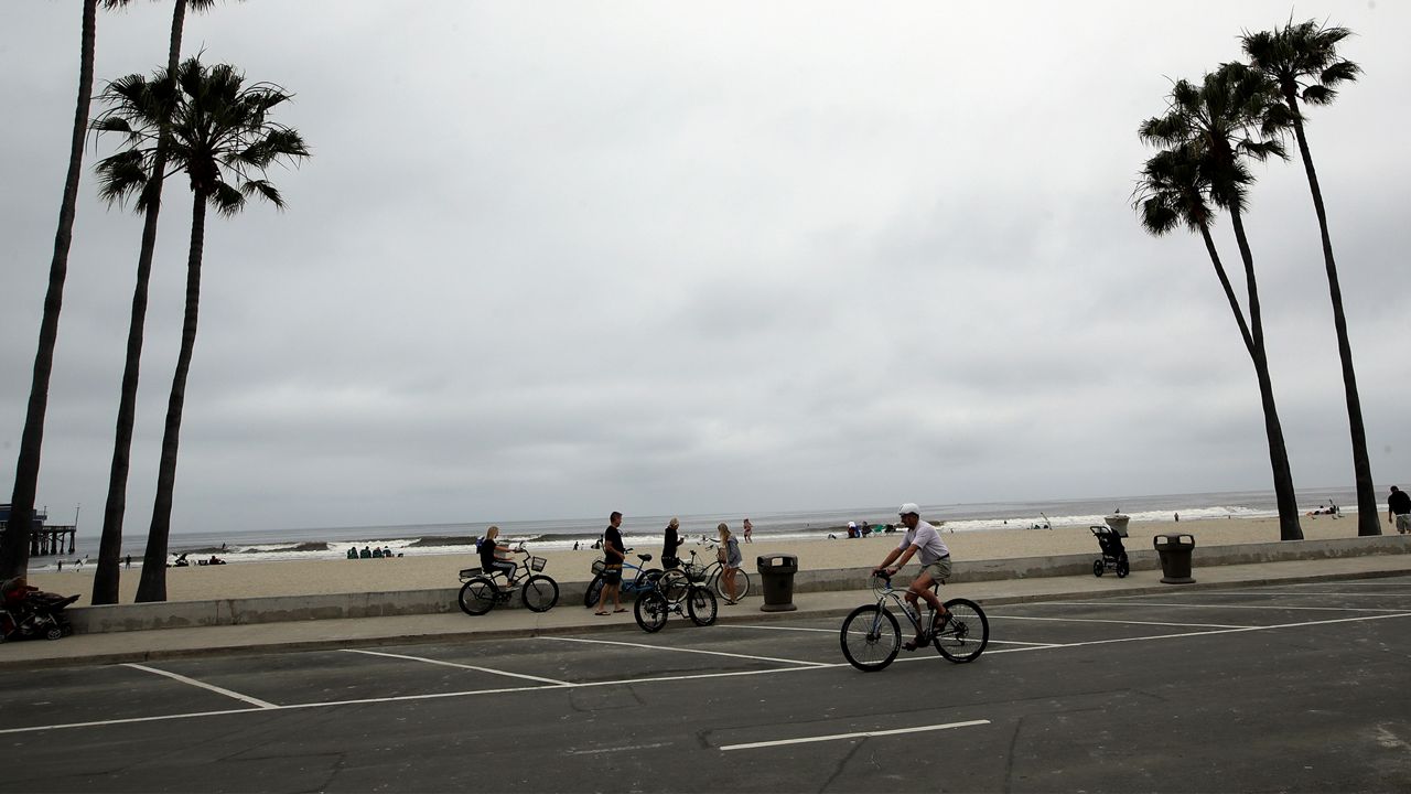 Cyclists converge on a beach front trail Thursday, April 30, 2020, in Newport Beach, Calif. (AP Photo/Marcio Jose Sanchez)