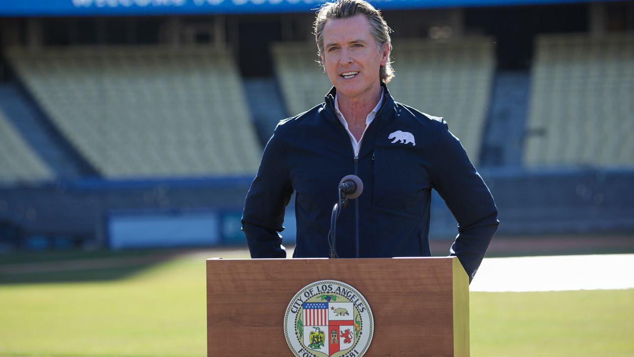 Governor Gavin Newsom addresses a press conference held at the launch of a mass COVID-19 vaccination site at Dodger Stadium, Friday, Jan. 15, 2021, in Los Angeles. (Irfan Khan/Los Angeles Times via AP, Pool)