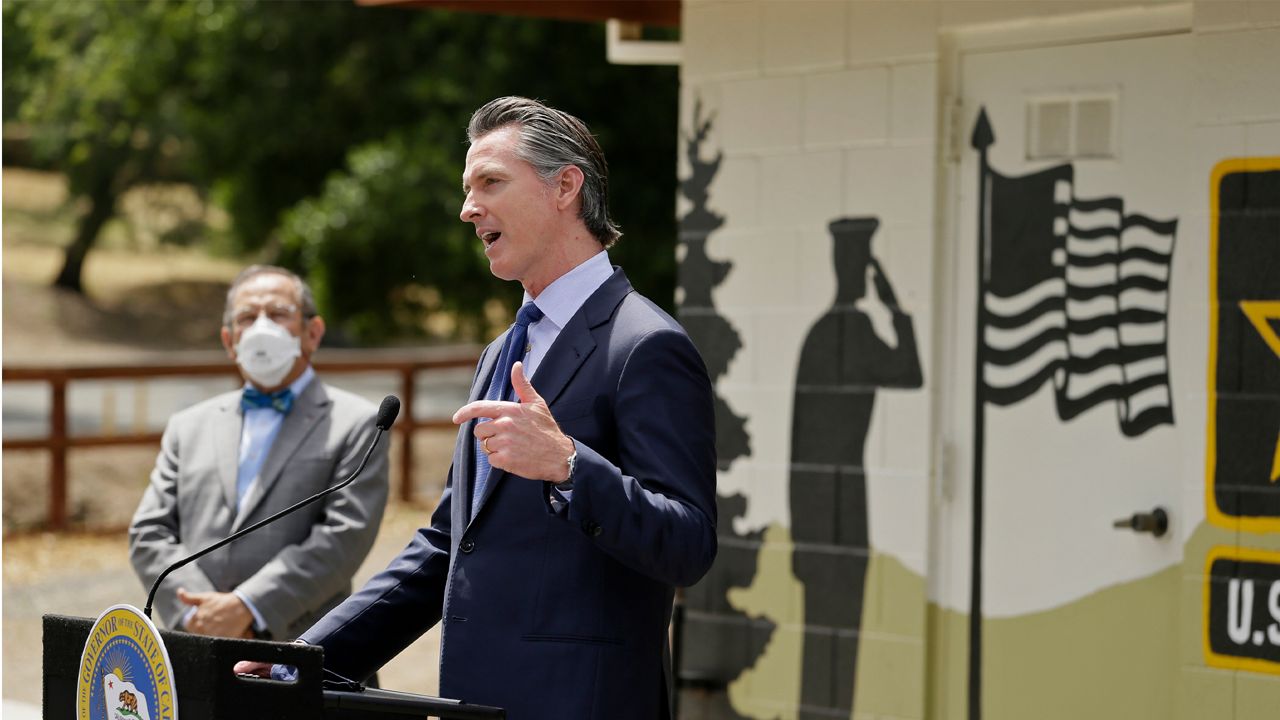 California Gov. Gavin Newsom gestures during a news conference as CalVet Secretary Vito Imbasciani looks on at the Veterans Home of California, Friday, May 22, 2020, in Yountville, Calif. (AP Photo/Eric Risberg, Pool)