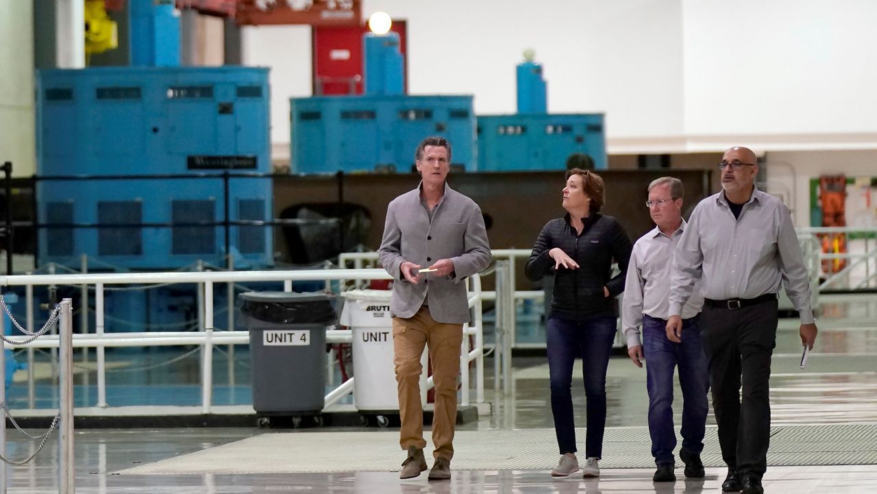Gov. Gavin Newsom, left, tours the Edward Hyatt Power Plant at the Oroville Dam with Department of Water Resources Director Karla Nemeth, second left, in Oroville, Calif., April 19, 2022. (AP Photo/Rich Pedroncelli, File)