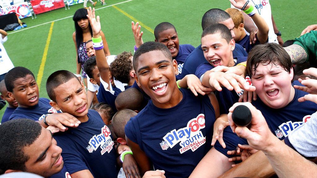 A peek into a huddle during the NFL PLAY60 Youth Football Festival on Wednesday, Sept. 5, 2012 at Chelsea Waterside Park in New York. (John Minchillo/AP Images for NFL)