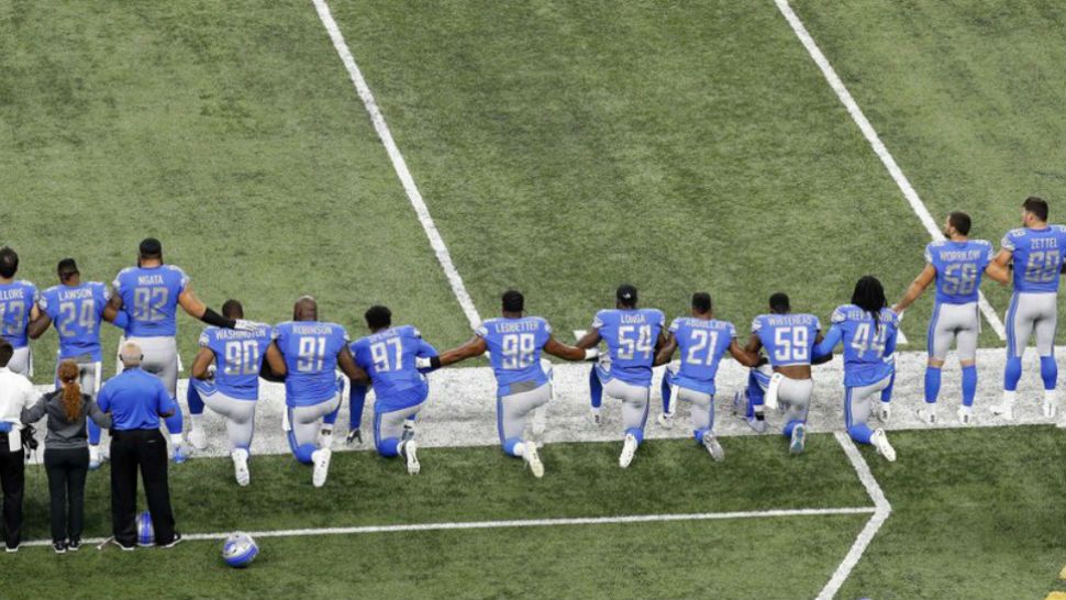 In this Sept. 24, 2017, file photo, Detroit Lions players take a knee during the national anthem before an NFL football game against the Atlanta Falcons in Detroit. President Donald Trump's feud with the NFL about players kneeling during the national anthem is the runaway winner for the top sports story of 2017 in balloting by AP members and editors. (AP Photo/Paul Sancya)