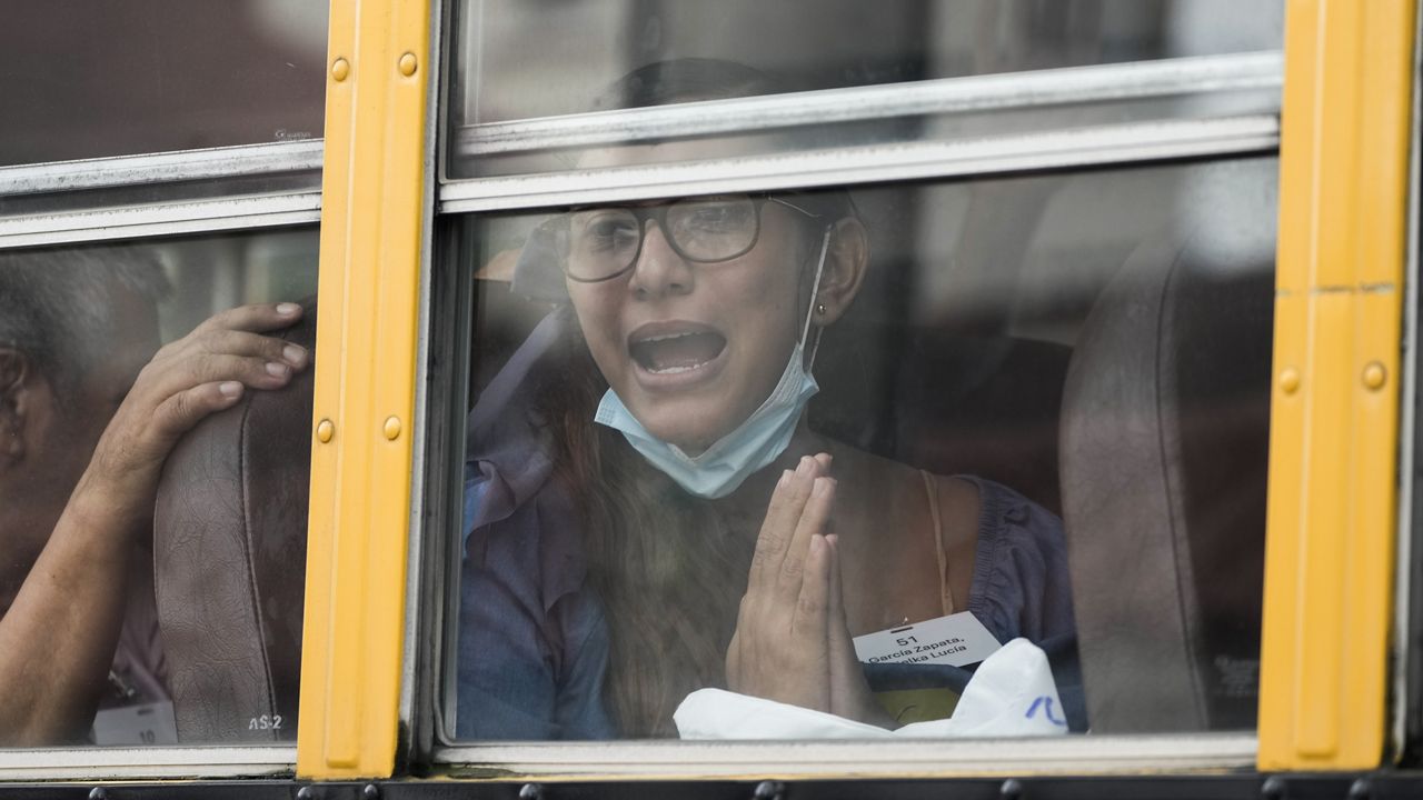 Lucia Garcia gestures from a bus after being released from a Nicaraguan jail and landing at the airport in Guatemala City, Thursday, Sept. 5, 2024. (AP Photo/Moises Castillo)