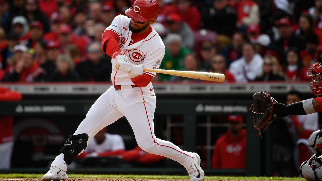 Cincinnati Reds' Nick Martini (23) takes a swing during the second inning of an opening day baseball game against the Washington Nationals in Cincinnati, Thursday, March 28, 2024. (AP Photo/Timothy D. Easley)