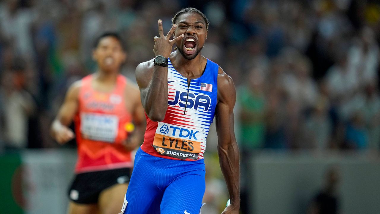 Noah Lyles, of the United States celebrates anchoring his team to gold in the Men's 4x100-meters relay final during the World Athletics Championships in Budapest, Hungary, Saturday, Aug. 26, 2023. (AP Photo/Ashley Landis, File)