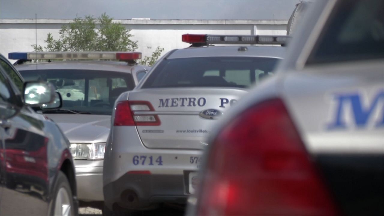 Squad cars parked at Louisville, KY police station.