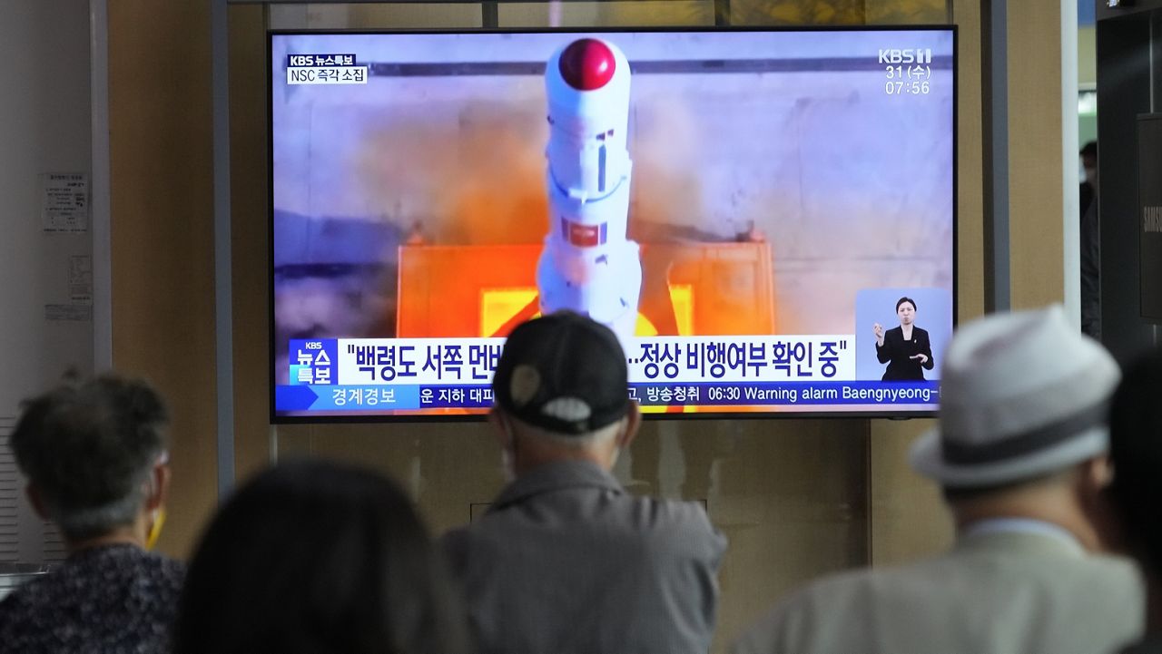 A TV screen on Wednesday shows a file image of North Korea's rocket launch during a news program at the Seoul Railway Station in Seoul, South Korea. North Korea launched a purported rocket Wednesday, a day after the country announced a plan to put its first military spy satellite into orbit, South Korea's military said. (AP Photo/Ahn Young-joon)