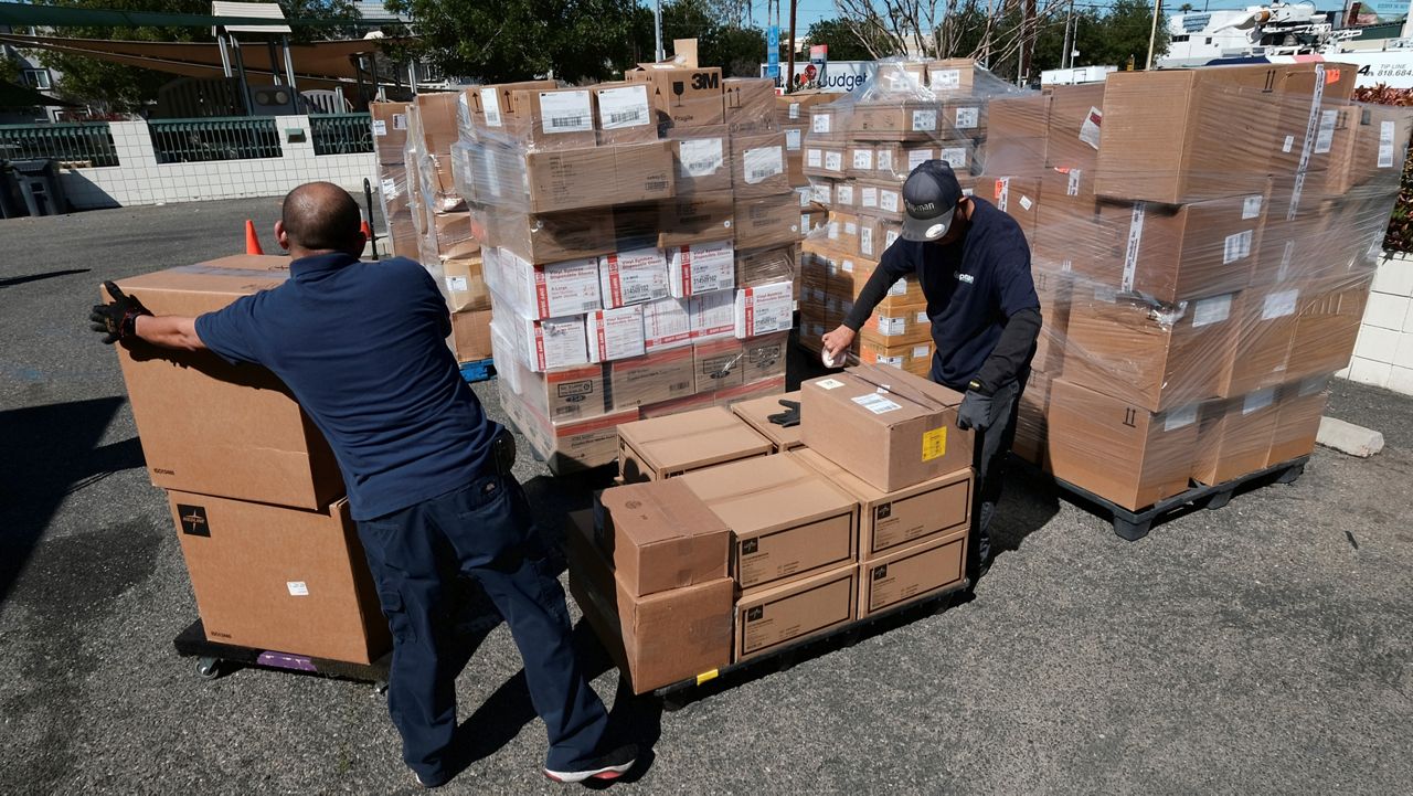 Workers load pallets with boxes of medical supplies to aid Ukrainians from Dignity Health - Northridge Hospital Medical Center in Los Angeles on Thursday, March 10, 2022. (AP Photo/Richard Vogel)