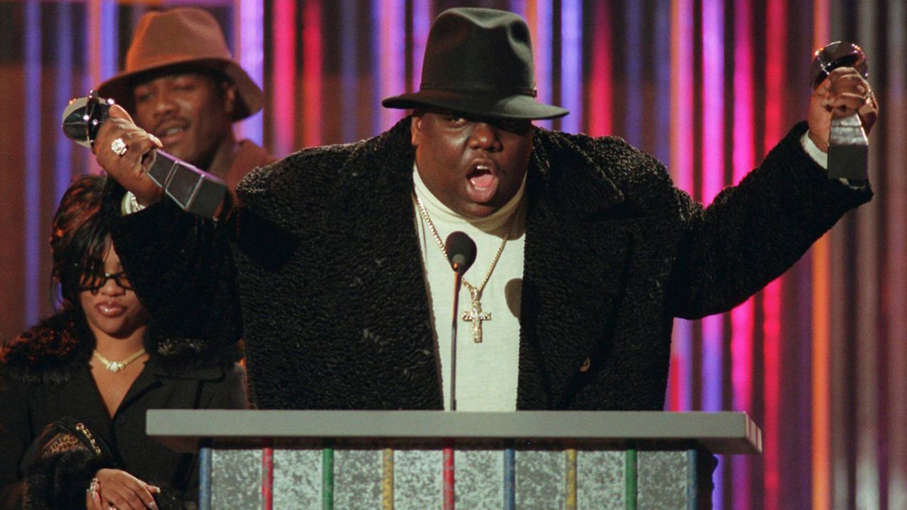 Notorious B.I.G., who won rap artist and rap single of the year, clutches his awards at the podium during the Billboard Music Awards in New York, on evening, Dec. 6, 1995. (AP Photo/Mark Lennihan)