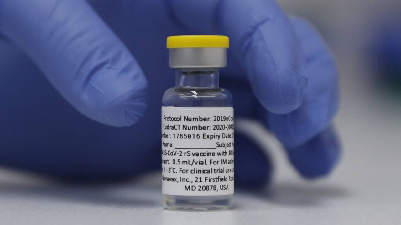 FILE - In this Wednesday, Oct. 7, 2020, file photo, a vial of the Phase 3 Novavax coronavirus vaccine is seen ready for use in the trial at St. George's University hospital in London. (AP Photo/Alastair Grant, File)