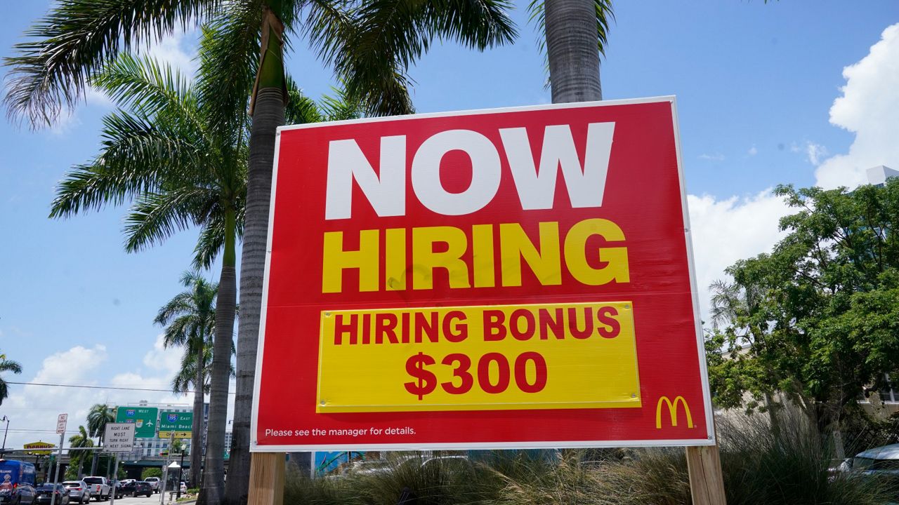 A sign offering a $300 hiring bonus is posted at a McDonald's restaurant on June 17 in Miami. (AP Photo/Marta Lavandier)