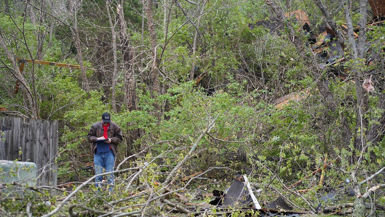 An NWS emergency official surveys damage from an EF-1 tornado on Thursday, April 6, 2023, in Louisville, Ky. (Spectrum News 1/Jonathon Gregg)