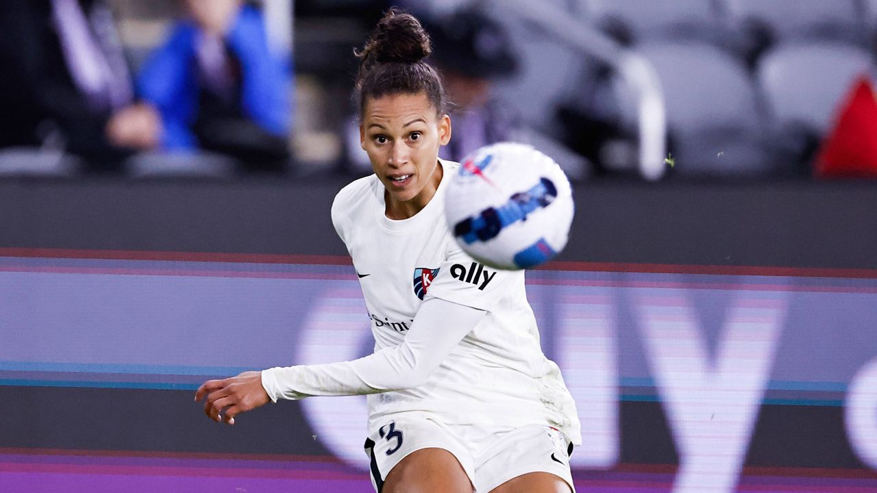 Kansas City defender Kristen Edmonds (3) passes the ball during an NWSL Challenge Cup soccer match against Racing Louisville FC, Friday, March 18, 2022, in Louisville, Ky. (AP Photo/Wade Payne)