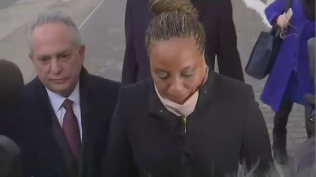 Assemblywoman Pamela Harris, center, wearing a black coat and a beige scarf. A man in a black coat is to her right. Two people dressed warmly are behind her.