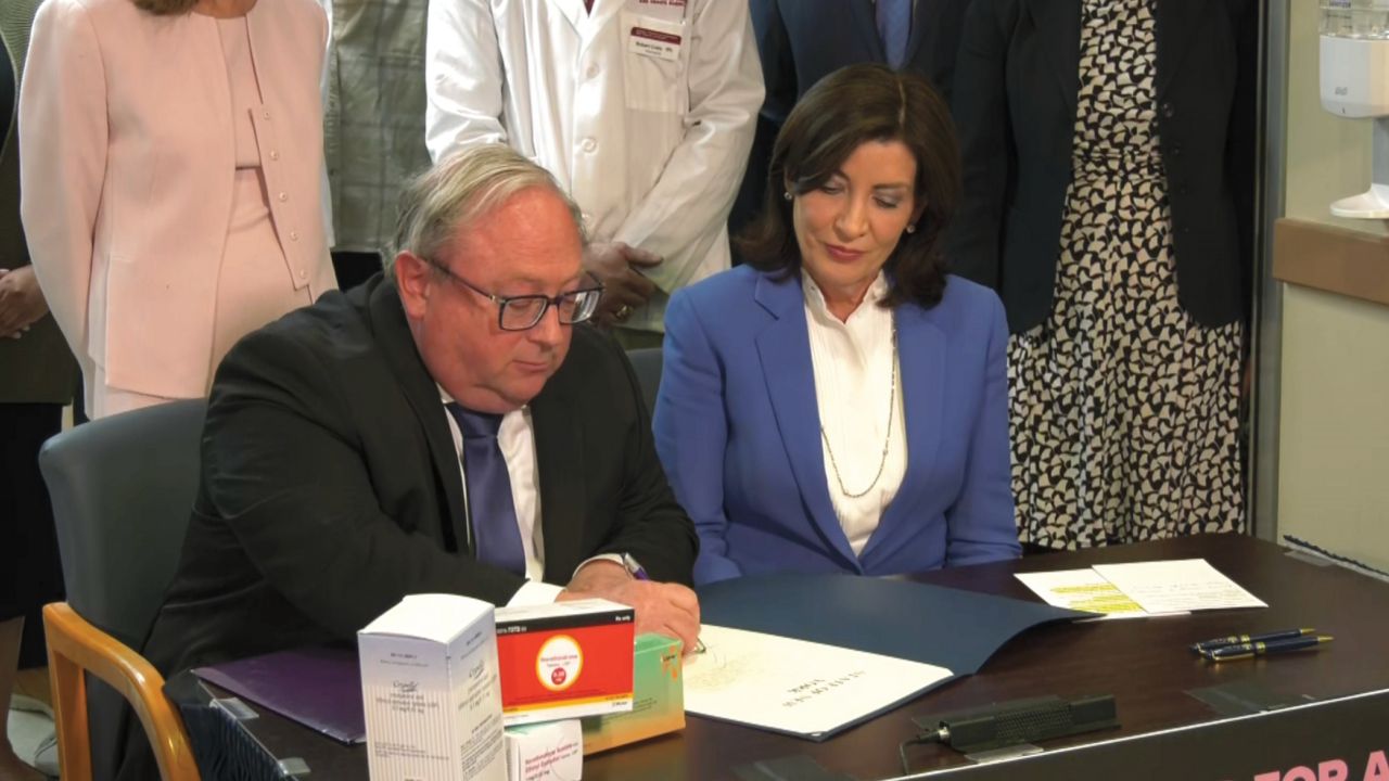 health commissioner signs order with governor