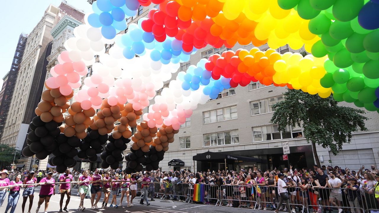Rainbow balloons are carried down the parade route during the NYC Pride March on Sunday. (Photo by Charles Sykes/Invision/AP)