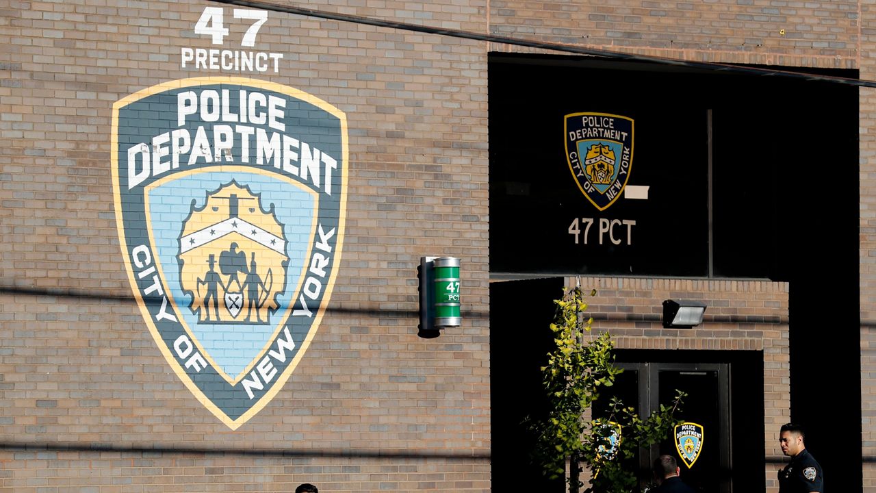 Police officers stand in front of the 47th precinct in the Bronx borough of New York, Sunday, Sept. 29, 2019. (AP Photo/Seth Wenig, File)