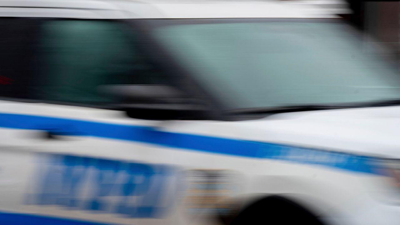 A police car drives through the Brooklyn borough of New York on Friday, Dec. 16, 2022.
