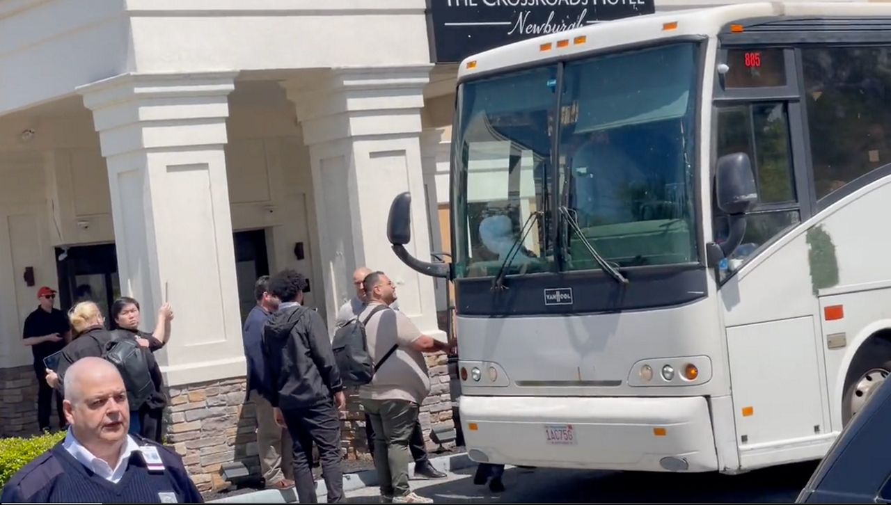 migrants prepare to exit bus at hudson valley hotel