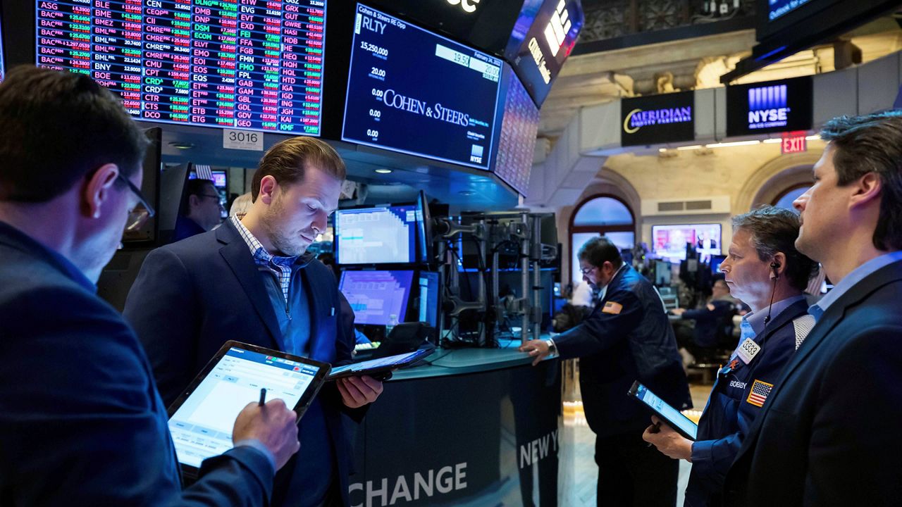 Traders gather Thursday at a post on the New York Stock Exchange floor. (Courtney Crow/New York Stock Exchange via AP)