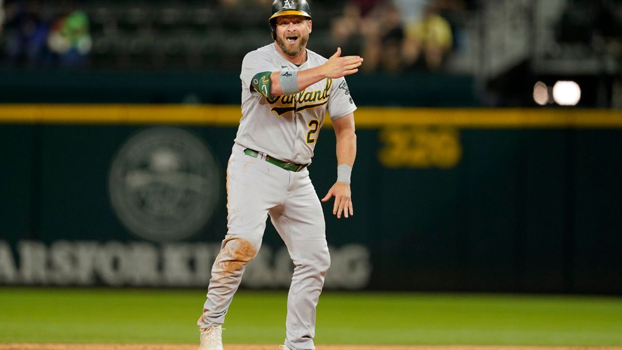 Oakland Athletics' Stephen Vogt (21) stands on second celebrating his run-scoring single in the ninth inning of a baseball game against the Texas Rangers in Arlington, Texas, Wednesday, Sept. 14, 2022. Eric Martins scored on the hit and Vogt advanced to second on the play. (AP Photo/Tony Gutierrez)