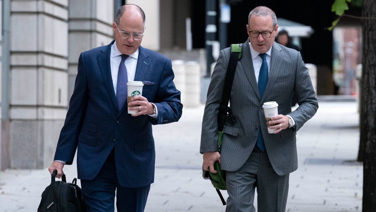 Attorneys of Oath Keepers leader Stewart Rhodes, Phillip Linder, left, and James Lee Bright, arrive Tuesday at the federal courthouse in Washington. (AP Photo/Jose Luis Magana)