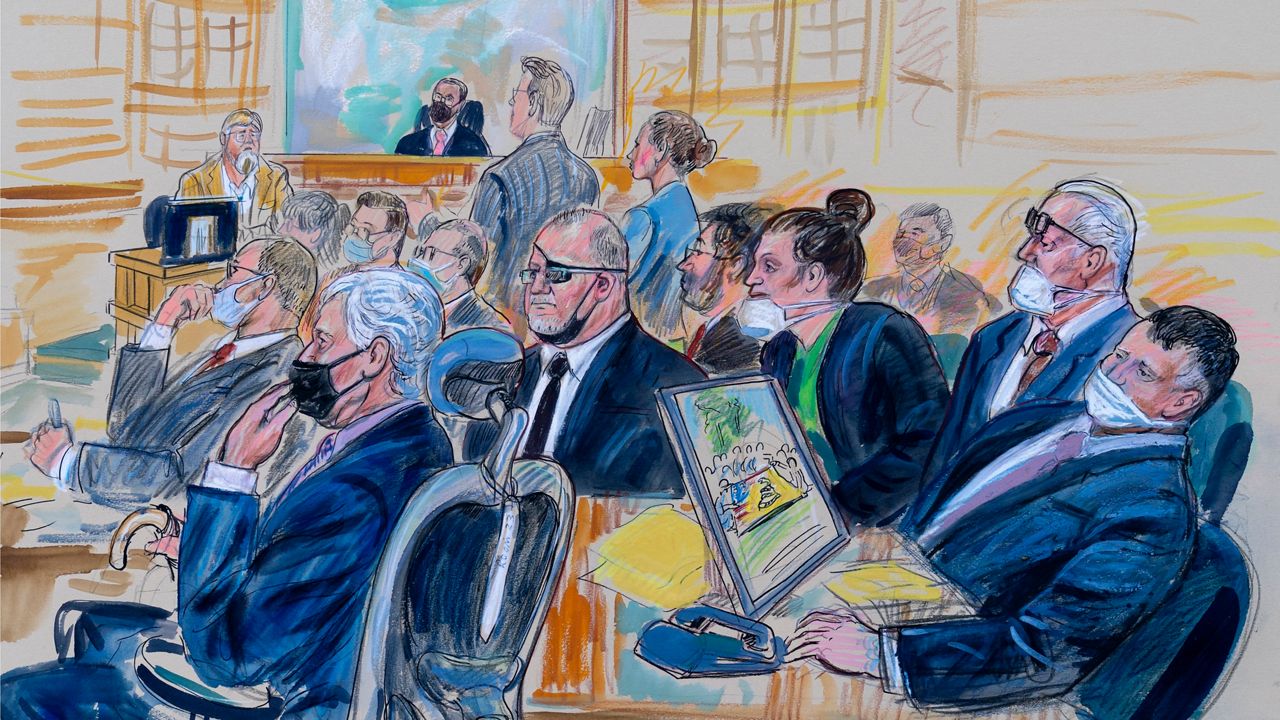 This artist sketch depicts the trial of Oath Keepers leader Stewart Rhodes and four others charged with seditious conspiracy in the Jan. 6, 2021, Capitol attack, in Washington, Oct. 6, 2022. Shown above are, witness John Zimmerman, who was part of the Oath Keepers' North Carolina Chapter, seated in the witness stand, defendant Thomas Caldwell, of Berryville, Va., seated front row left, Oath Keepers leader Stewart Rhodes, seated second left with an eye patch, defendant Jessica Watkins, of Woodstock, Ohio, seated third from right, Kelly Meggs, of Dunnellon, Fla., seated second from right, and defendant Kenneth Harrelson, of Titusville, Fla., seated at right. Assistant U.S. Attorney Kathryn Rakoczy is shown in blue standing at right before U.S. District Judge Amit Mehta. Watkins told jurors Wednesday, Nov. 16 that it was a "really stupid" decision, saying she got swept up in what seemed to be a "very American moment." (Dana Verkouteren via AP)