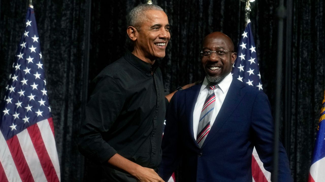 Former President Barack Obama, left, greets Sen. Raphael Warnock, D-Ga., before Obama speaks during a rally Thursday  in Atlanta. (AP Photo/Brynn Anderson)