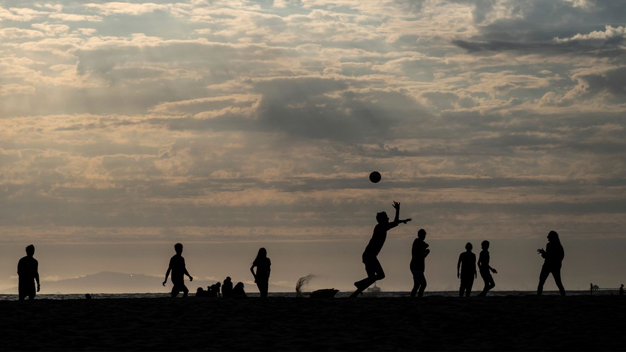People play soccer on the beach, Tuesday, June 22, 2021, in Newport Beach, Calif. (AP Photo/Jae C. Hong)