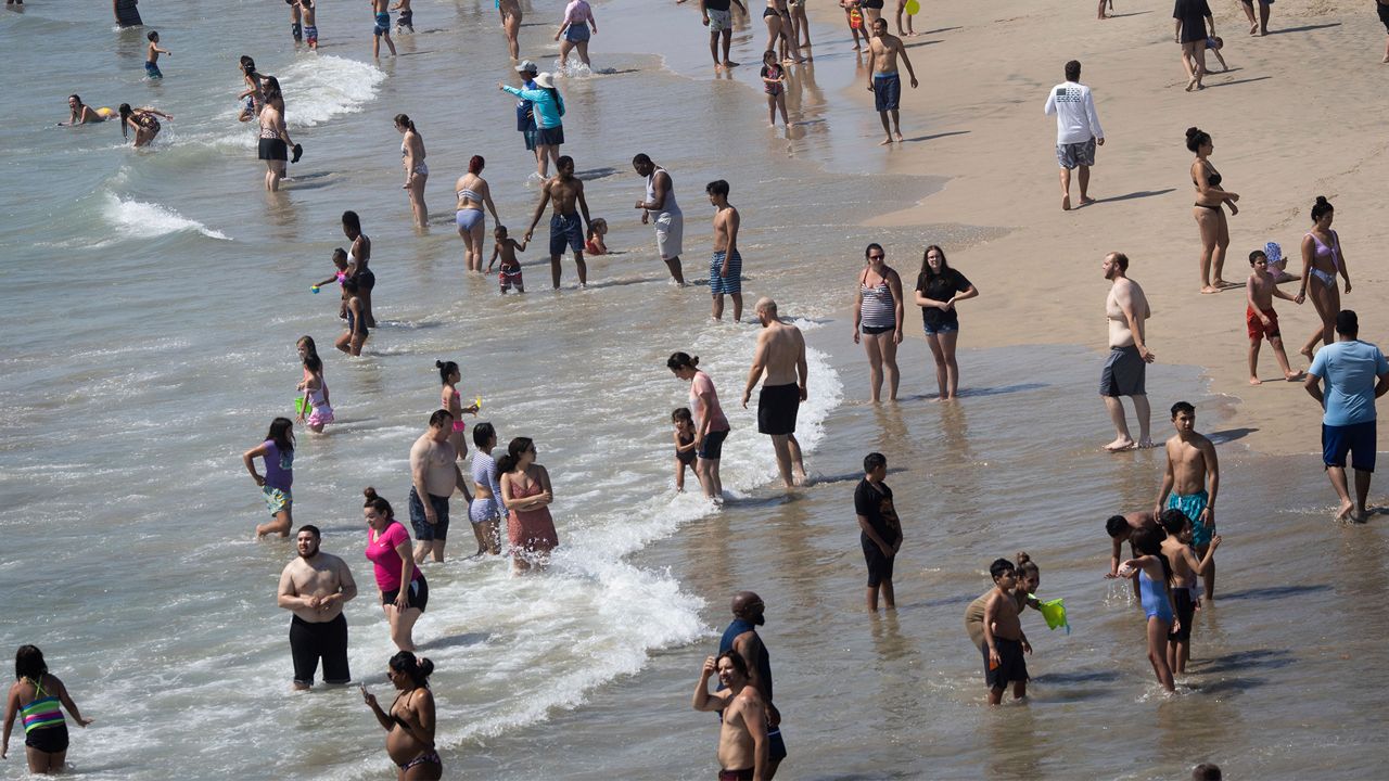People are seen at the beach during a heat wave, Sunday, Sept. 6, 2020, in Huntington Beach, Calif. (AP Photo/Christian Monterrosa)