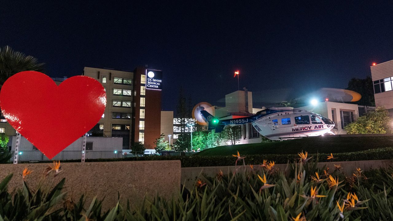 A Mercy Air Ambulance helicopter lands with an emergency patient at the heliport of the University of California Irvine Medical Center in Orange, Calif., Thursday, Oct. 14, 2021. (AP Photo/Damian Dovarganes)