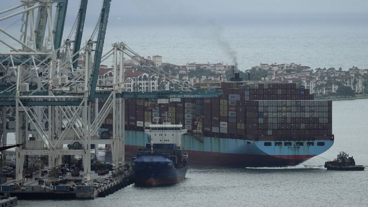 FILE - Tugboats guide the Axel Maersk container ship as it arrives into port, Oct. 21, 2021, in Miami. (AP Photo/Rebecca Blackwell, File)