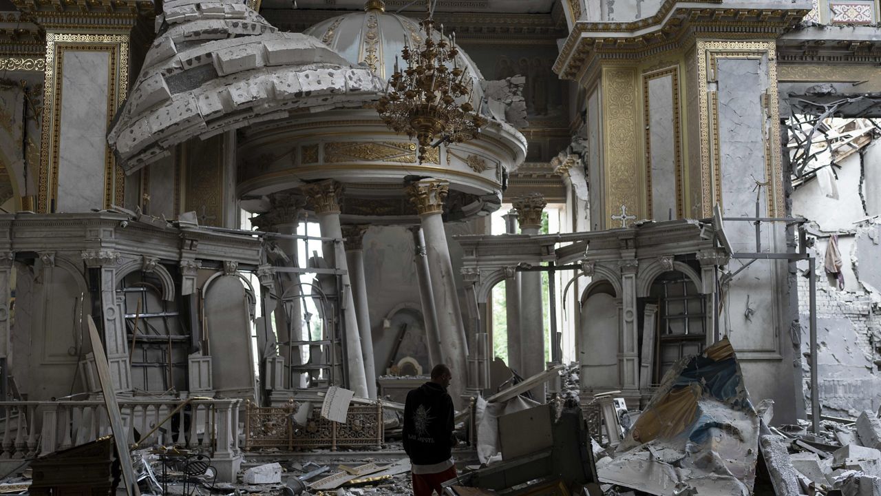 A church employee inspects damages Sunday inside the Odesa Transfiguration Cathedral in Odesa, Ukraine. (AP Photo/Jae C. Hong)