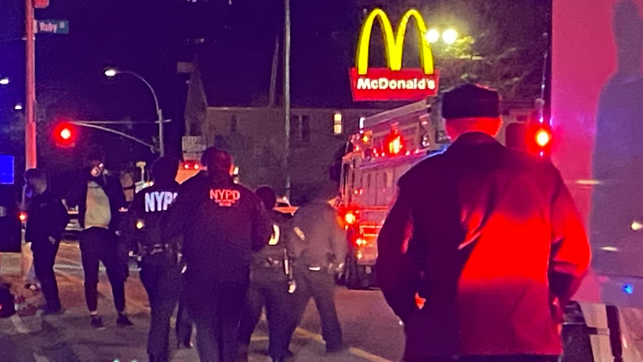 Law enforcement responds to the shooting of an off-duty NYPD officer in East New York Saturday night. (NY1/Ron Lee)