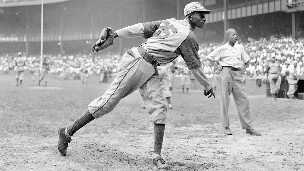 In this Aug. 2, 1942, file photo, Kansas City Monarchs pitcher Leroy Satchel Paige warms up at New York's Yankee Stadium before a Negro League game between the Monarchs and the New York Cuban Stars. Major League Baseball said Tuesday, May 28, 2024, that it has incorporated records for more than 2,300 Negro Leagues players following a three-year research project.