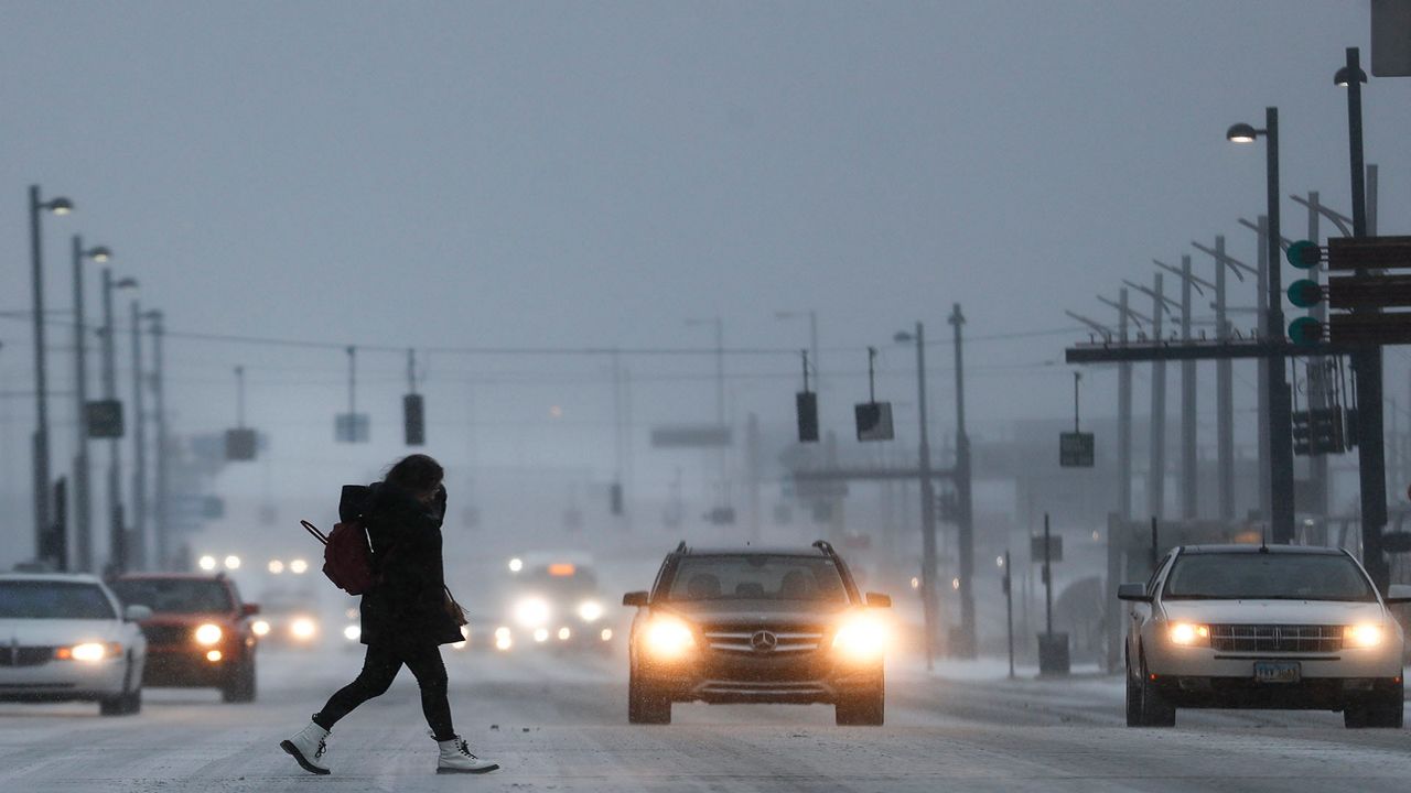 Commuters braves the wind and snow in frigid weather, Wednesday, Jan. 30, 2019, in Cincinnati. The extreme cold and record-breaking temperatures are crawling into a swath of states spanning from North Dakota to Missouri and into Ohio after a powerful snowstorm pounded the region earlier this week. (AP Photo/John Minchillo)