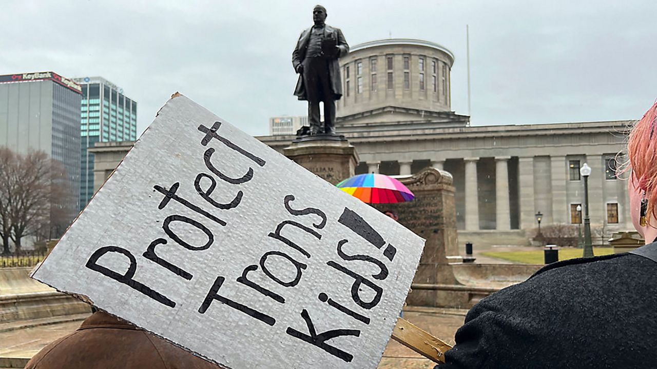 Protesters advocating for transgender rights and healthcare stand outside of the Ohio Statehouse on Wednesday, Jan. 24, 2024, in Columbus, Ohio.