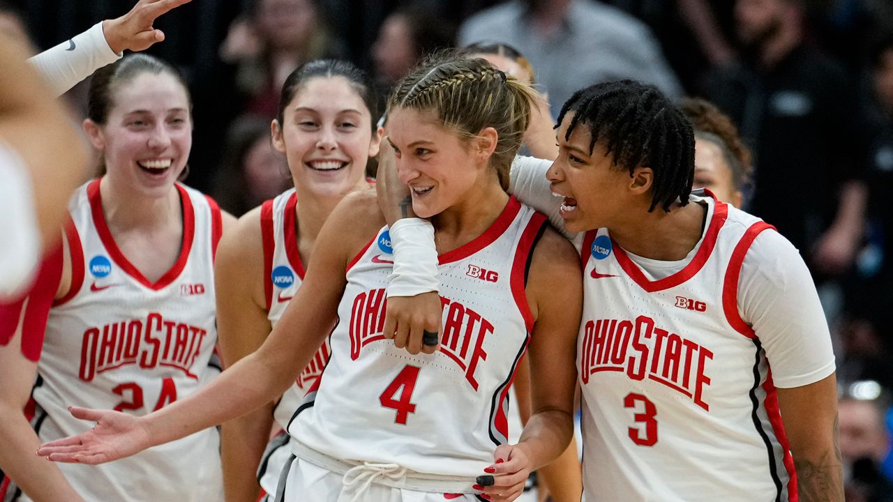 Ohio State guard Jacy Sheldon (4) is hugged by guard Hevynne Bristow (3) after Ohio State defeated North Carolina in a second-round college basketball game in the women's NCAA Tournament in Columbus, Ohio, Monday, March 20, 2023. Ohio State defeated North Carolina 71-69. (AP Photo/Michael Conroy)
