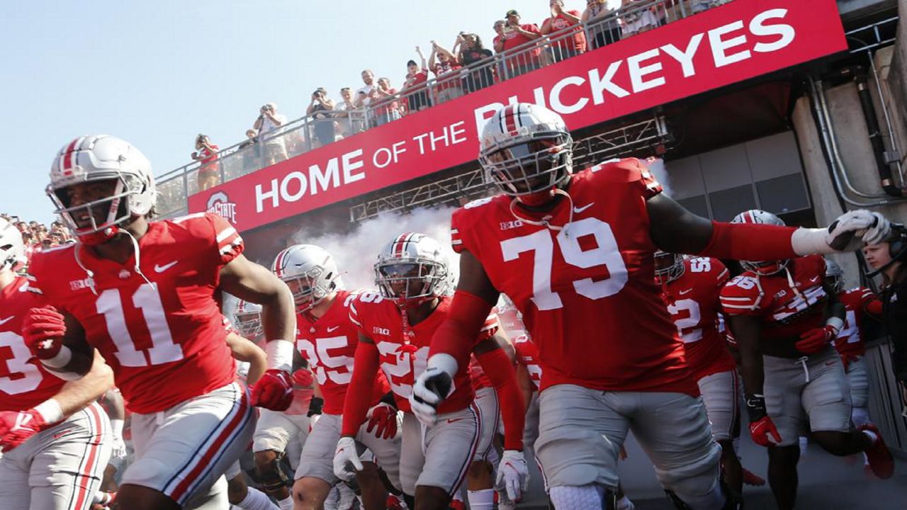 Ohio State players run onto the field before an NCAA college football game against Tulsa, Saturday, Sept. 18, 2021, in Columbus, Ohio. (AP Photo/Jay LaPrete)