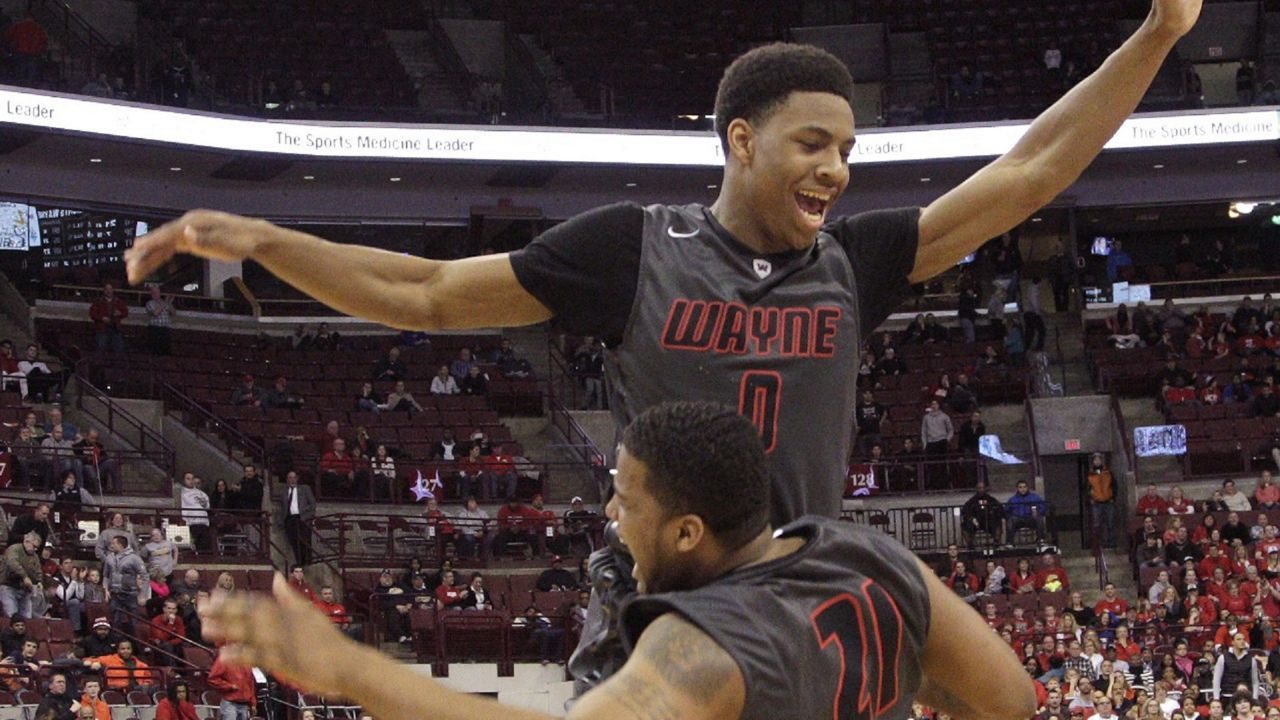 Huber Heights Wayne's Ahmad Wagner, top, and Guy Victoria celebrate their win over Westerville South in the Ohio High School Athletic Association Division I championship basketball game Saturday, March 28, 2015, in Columbus, Ohio. Wayne beat Westerville South 65-57. (AP Photo/Jay LaPrete)