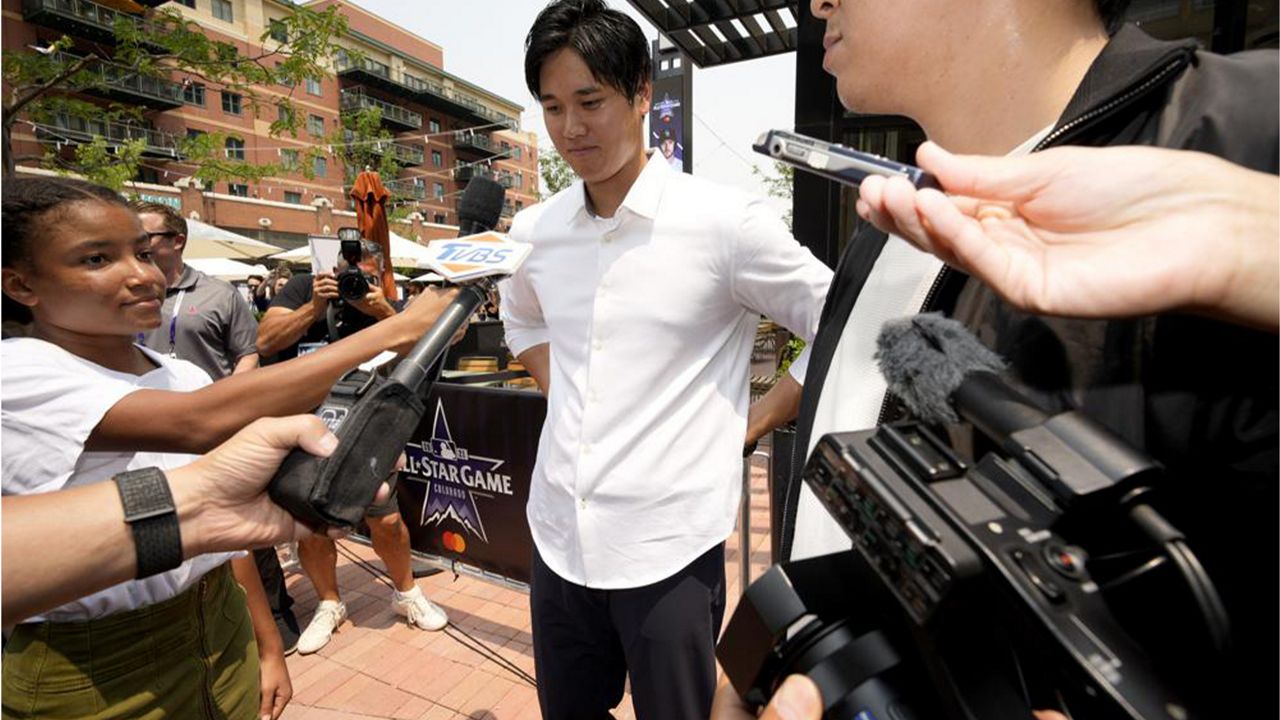 Shohei Ohtani, of the Los Angeles Angeles, larrives to a news conference to be named the American League's starting pitcher for the MLB All-Star baseball game, Monday, July 12, 2021, in Denver. (AP Photo/David Zalubowski)