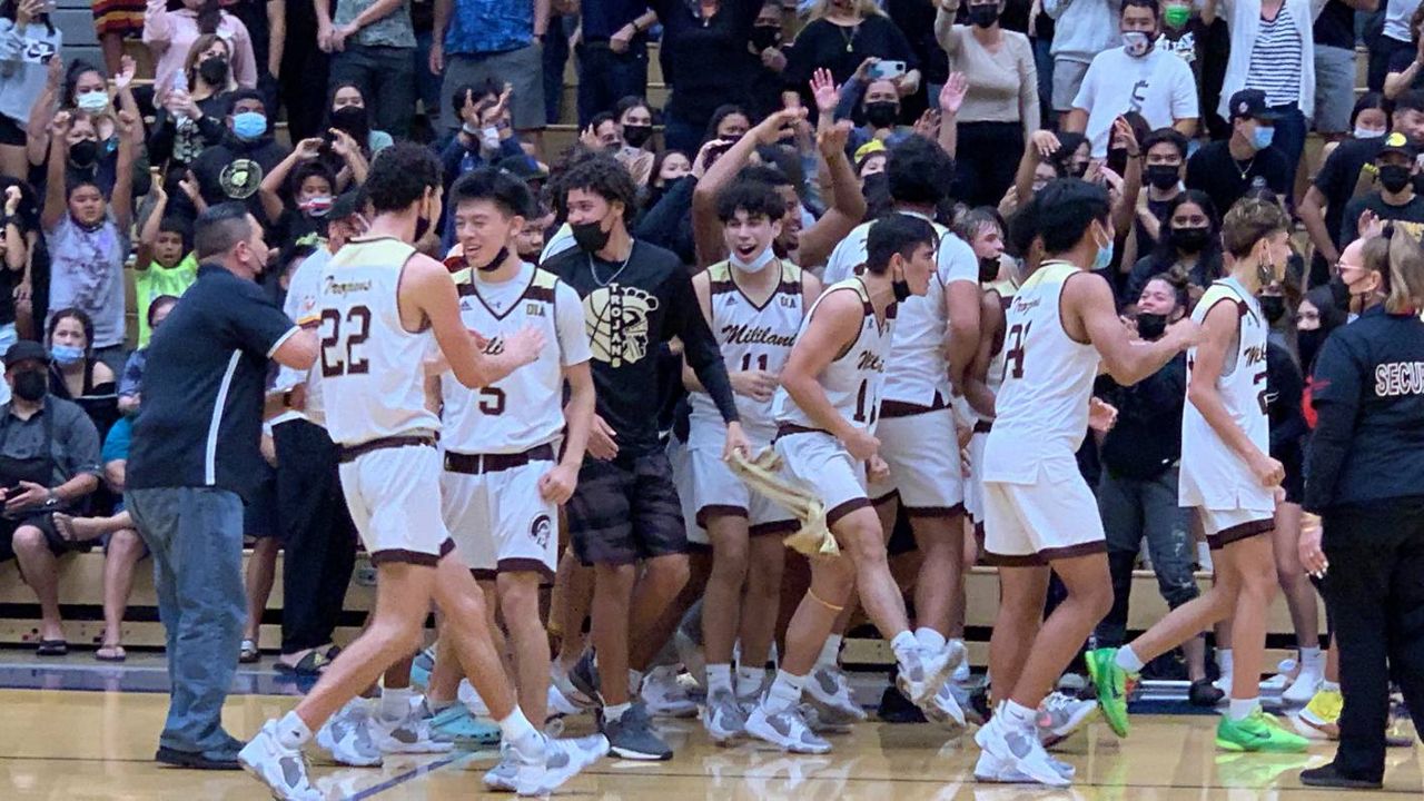 Mililani players mobbed each other celebrating their OIA Division I boys basketball championship win over Kailua in front of their fans at Moanalua's gym on Wednesday night. 