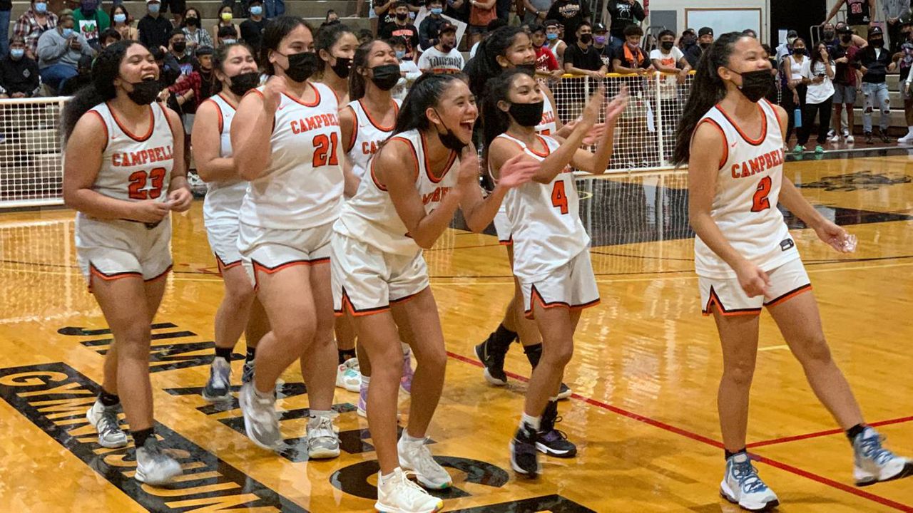 Campbell players celebrated after winning the first OIA girls basketball championship in program history.
