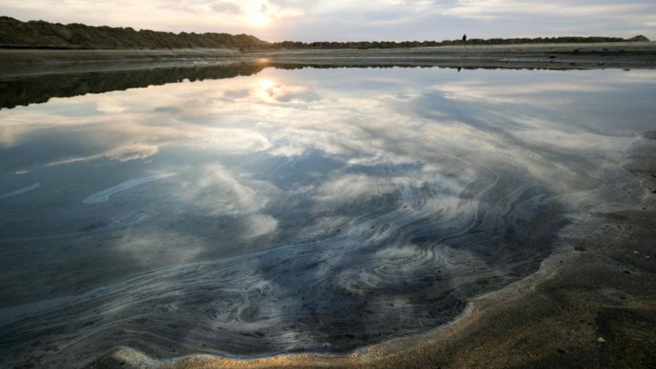 Oil floats on the water surface after an oil spill in Huntington Beach, Calif., on Monday, Oct. 4, 2021. (AP Photo/Ringo H.W. Chiu)