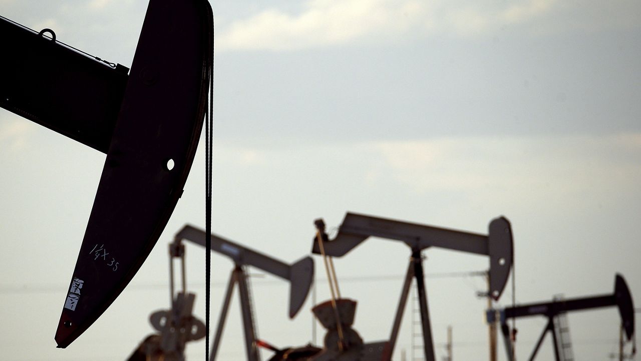 Pump jacks work in a field near Lovington, N.M., April 24, 2015. (AP Photo/Charlie Riedel, File)