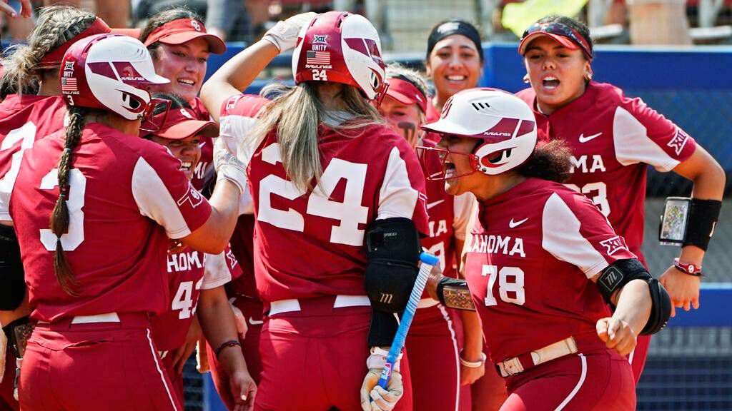 Hawaii native Jocelyn Alo, right, seen with her Oklahoma teammates on May 14, is heading back to the Women's College World Series to cap her college career.