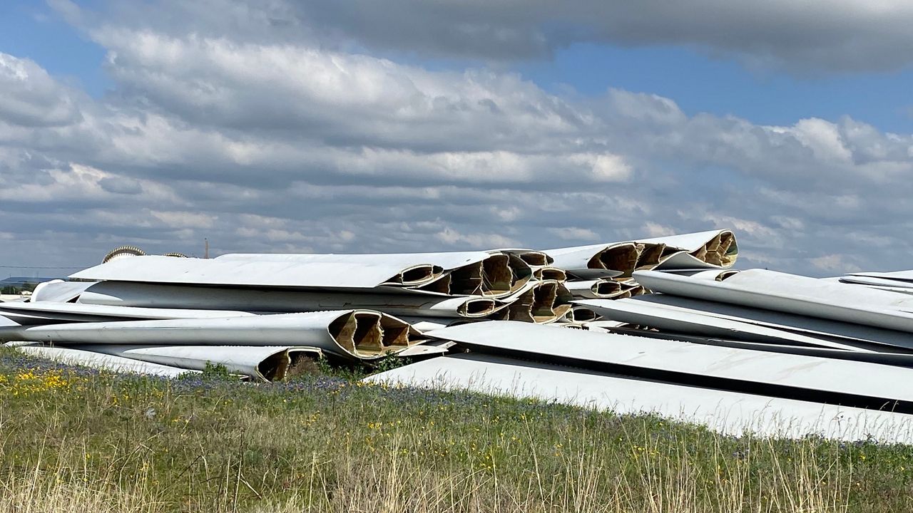 Piles of old wind blades are stacked on top of each other in a field managed by CPD in Sweetwater, Texas. 