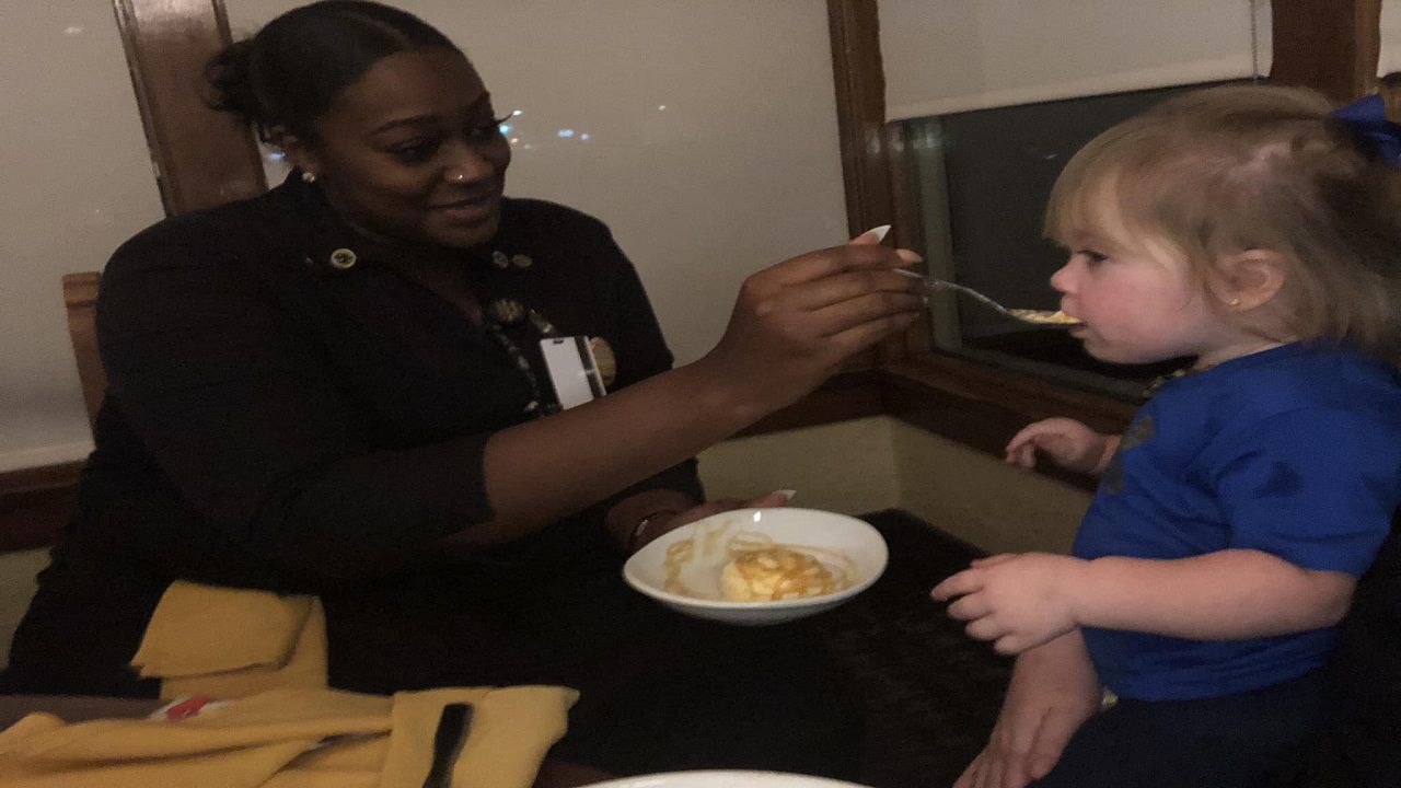 Waitress feeds child